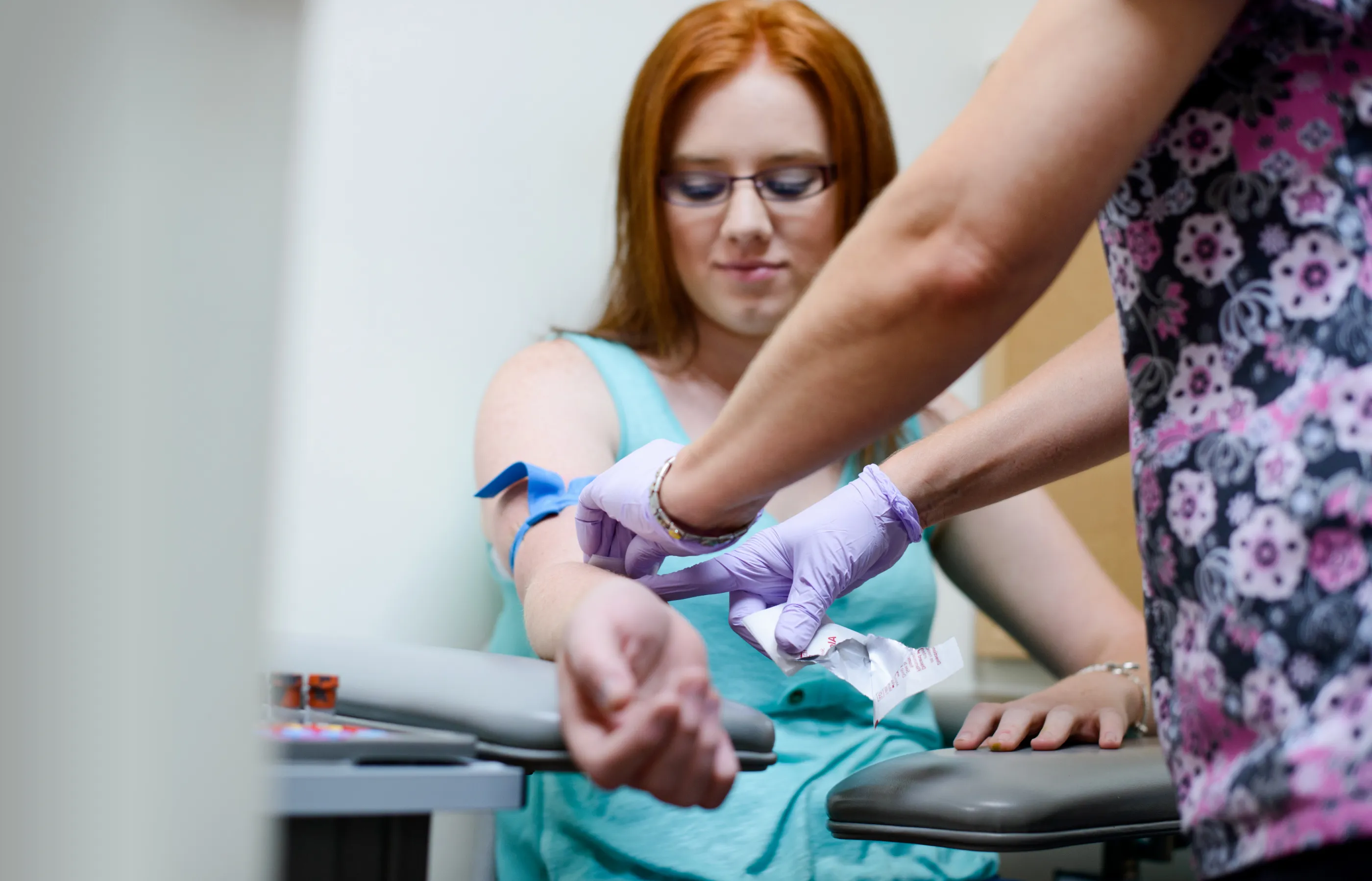 Nurse drawing a woman's blood for lab tests.