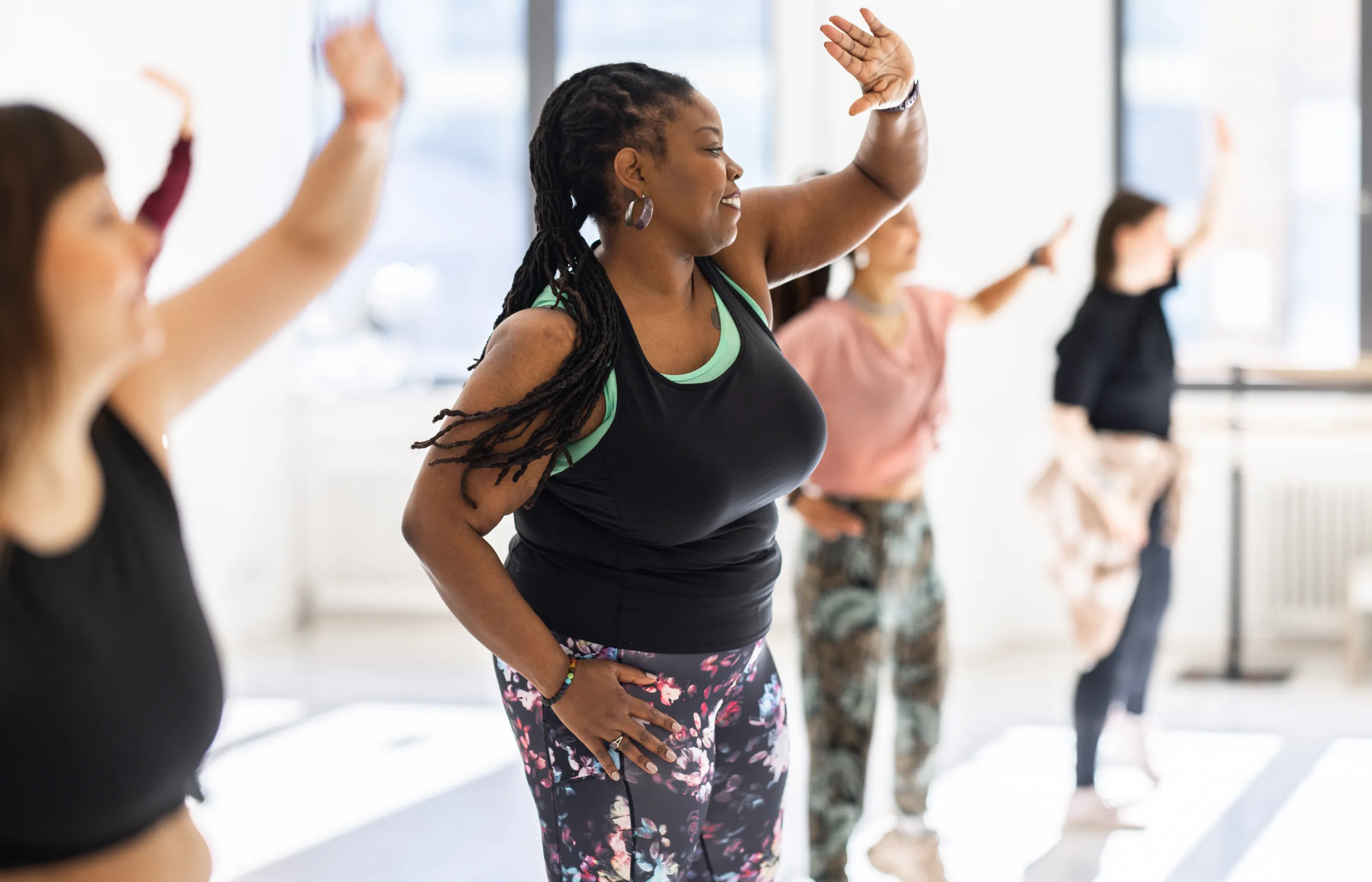 Group of women attending a fitness dance class.