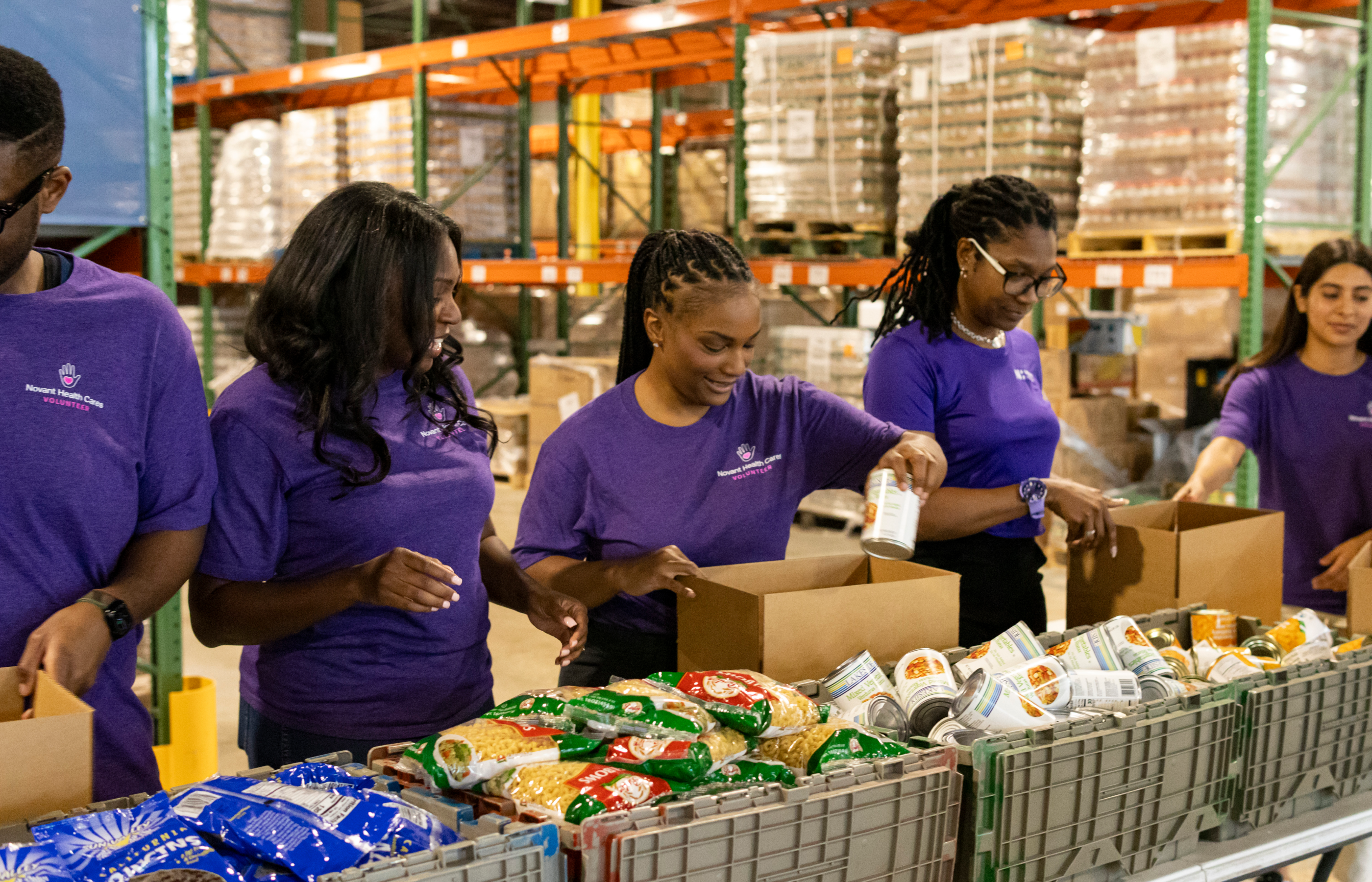 Team members volunteering to give out food boxes