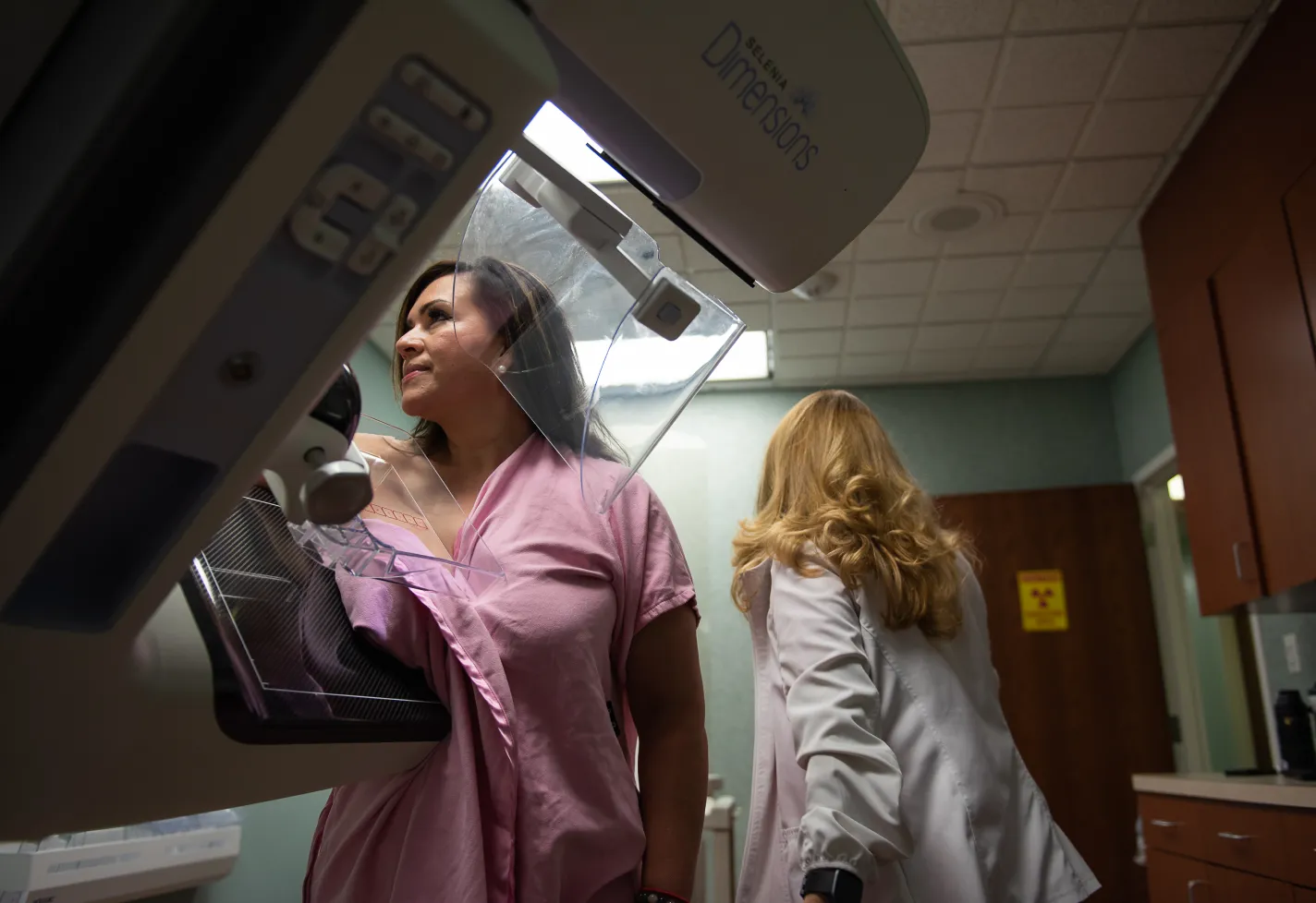 Woman having a mammography examination at a clinic with a female technician. Woman having a mammography examination at a clinic with a female technician.